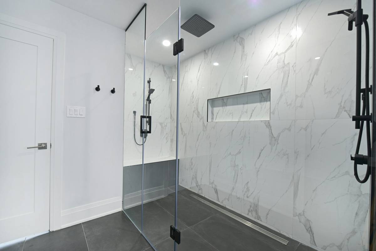 Close-up of a modern rainfall shower head with adjustable settings showing plumbing supply shower head type feature details like nozzles and flow regulator